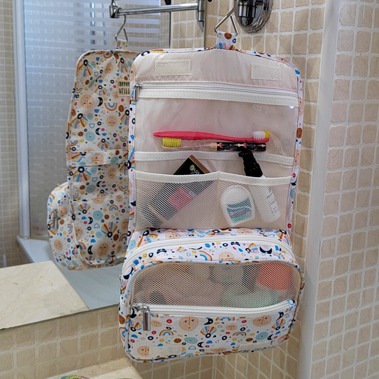 Patterned toiletry bag with items on a bathroom wall hook